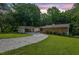 Charming single-story home with stone and brick exterior, surrounded by lush greenery and a well-manicured lawn at 4717 Westhampton Dr, Tucker, GA 30084