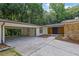 Beautiful home featuring a double door entrance, stone accents, fresh landscaping, and an attached carport at 4717 Westhampton Dr, Tucker, GA 30084