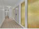 Bright hallway featuring hardwood floors, striking doors, and decorative glass panels leading to other rooms at 4717 Westhampton Dr, Tucker, GA 30084