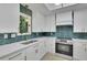 Bright kitchen features stainless steel oven, white cabinets, and teal backsplash at 4717 Westhampton Dr, Tucker, GA 30084