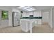 Bright kitchen features stainless steel appliances, white cabinets, and a large island at 4717 Westhampton Dr, Tucker, GA 30084