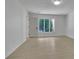 Large, bright living room with wood floors, a white door, and multiple windows overlooking a green landscape at 4717 Westhampton Dr, Tucker, GA 30084
