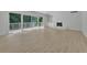 Bright living room featuring hardwood floors, large windows, a brick fireplace, and built-in shelving at 4717 Westhampton Dr, Tucker, GA 30084