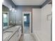 Bright bathroom featuring double sinks, granite countertops, and a separate bathtub with white tile at 629 Windsor Sw St, Atlanta, GA 30312
