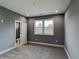 Bedroom with plush carpet, natural light, neutral walls, trim and access to a bathroom at 629 Windsor Sw St, Atlanta, GA 30312