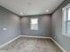 This is a bedroom featuring plush carpet, a window letting in natural light and neutral walls at 629 Windsor Sw St, Atlanta, GA 30312