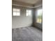 Bright bedroom with three windows and neutral carpet flooring at 115 Pinecone Pkwy, Alpharetta, GA 30022