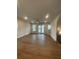Bright and airy living area featuring hardwood floors and access to outdoor living spaces at 115 Pinecone Pkwy, Alpharetta, GA 30022