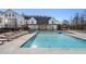 Community pool with lounge chairs and a clubhouse at 115 Pinecone Pkwy, Alpharetta, GA 30022