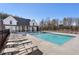 Community pool with lounge chairs and clubhouse at 115 Pinecone Pkwy, Alpharetta, GA 30022