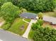 Aerial view of home with manicured lawn, long driveway, mature trees, and neat landscaping at 174 Zelma Sw St, Marietta, GA 30060