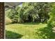 Expansive backyard featuring a large, well-maintained lawn, mature trees, and a peaceful, natural setting at 174 Zelma Sw St, Marietta, GA 30060