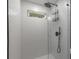 Modern bathroom shower featuring sleek white tiling and black fixtures, creating a clean, contemporary design at 174 Zelma Sw St, Marietta, GA 30060