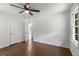 Bedroom features hardwood floors, a ceiling fan, closet, and doorway leading to other parts of the home at 174 Zelma Sw St, Marietta, GA 30060