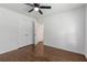 Bedroom features hardwood floors, a ceiling fan, closet, and doorway leading to other parts of the home at 174 Zelma Sw St, Marietta, GA 30060