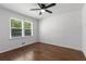 Bright bedroom with hardwood floors, ceiling fan, and large window offering plenty of natural light at 174 Zelma Sw St, Marietta, GA 30060