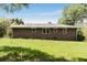 Brick home exterior, showing backyard lawn, window placement, roof and an AC Unit at 174 Zelma Sw St, Marietta, GA 30060