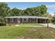 Charming brick home featuring a well-manicured lawn, front carport, and inviting entryway, perfect for suburban living at 174 Zelma Sw St, Marietta, GA 30060