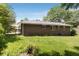 Brick home exterior, showcasing a well-kept lawn, a covered side porch, and mature landscaping in the backyard at 174 Zelma Sw St, Marietta, GA 30060