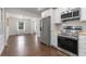 Modern kitchen with stainless steel appliances, white cabinets, wood counters and tile backsplash at 174 Zelma Sw St, Marietta, GA 30060