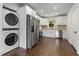 Modern kitchen with stainless steel appliances, white cabinets, wood counters and washer/dryer at 174 Zelma Sw St, Marietta, GA 30060