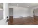 Bright living room boasts pristine white walls, gleaming hardwood floors, and ample natural light, creating a welcoming space at 174 Zelma Sw St, Marietta, GA 30060