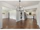 Bright, open-concept living space with a modern chandelier, washer/dryer and eat-in kitchen at 174 Zelma Sw St, Marietta, GA 30060