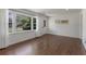 Bright living room boasts pristine white walls, gleaming hardwood floors, and ample natural light, creating a welcoming space at 174 Zelma Sw St, Marietta, GA 30060