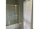 Bathroom with shower and tub and natural light from window at 386 Teal Ct, Roswell, GA 30076
