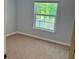 Carpeted bedroom with window and neutral paint at 386 Teal Ct, Roswell, GA 30076