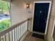 A covered porch leads to a classic navy blue front door with traditional hardware at 386 Teal Ct, Roswell, GA 30076