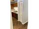 Shows the kitchen sink, a dishwasher, wooden cabinets and a walk in closet at 386 Teal Ct, Roswell, GA 30076