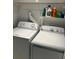 Washer and dryer in laundry room with storage shelves and cleaning supplies at 386 Teal Ct, Roswell, GA 30076