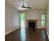 Living room with a fireplace, hardwood floors, and an outdoor access door at 386 Teal Ct, Roswell, GA 30076