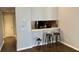 Open living space featuring a bar area, dark hardwood floors, and neutral wall paint at 386 Teal Ct, Roswell, GA 30076