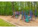 Community playground with play structure, swings, and slides at 386 Teal Ct, Roswell, GA 30076