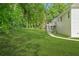Spacious backyard with lush green grass and trees at 4638 Arrow Wind Dr, Powder Springs, GA 30127