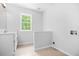 Bathroom features a single sink vanity, window, and neutral tile flooring at 4638 Arrow Wind Dr, Powder Springs, GA 30127