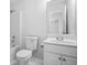 Light-filled bathroom with white vanity, tiled floors, toilet, tub, and shower at 4638 Arrow Wind Dr, Powder Springs, GA 30127