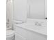 Updated bathroom with white vanity, mirror, bathtub, and toilet at 4638 Arrow Wind Dr, Powder Springs, GA 30127