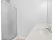 Bathroom with glass-enclosed shower and single sink vanity at 4638 Arrow Wind Dr, Powder Springs, GA 30127