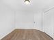 A bright empty bedroom with a double door closet and hardwood floors at 4638 Arrow Wind Dr, Powder Springs, GA 30127