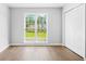 A well-lit bedroom with a double window showcasing the lawn and a double door closet for storage at 4638 Arrow Wind Dr, Powder Springs, GA 30127