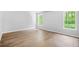 Bright bedroom featuring hardwood floors and large windows with views of nature at 4638 Arrow Wind Dr, Powder Springs, GA 30127