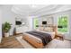 Bedroom with a tray ceiling, wood-look floors, and serene decor at 4638 Arrow Wind Dr, Powder Springs, GA 30127