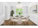 Elegant dining room featuring modern light fixture, stylish decor, and wainscoting detail at 4638 Arrow Wind Dr, Powder Springs, GA 30127