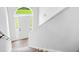 Bright entryway with natural light, white walls, wooden stairs and railings, and a view through the arched doorway at 4638 Arrow Wind Dr, Powder Springs, GA 30127