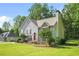 Charming two-story home with a well-manicured lawn, stone accents, red shutters, and a bright red front door, with driveway at 4638 Arrow Wind Dr, Powder Springs, GA 30127