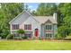 Charming two-story home with a well-manicured lawn, stone accents, red shutters and a bright red front door at 4638 Arrow Wind Dr, Powder Springs, GA 30127