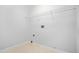 Bright laundry room with tile floors, white walls, and a wire shelf for storage at 4638 Arrow Wind Dr, Powder Springs, GA 30127